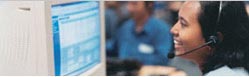 An image of an travel agent talking via a headset to a customer